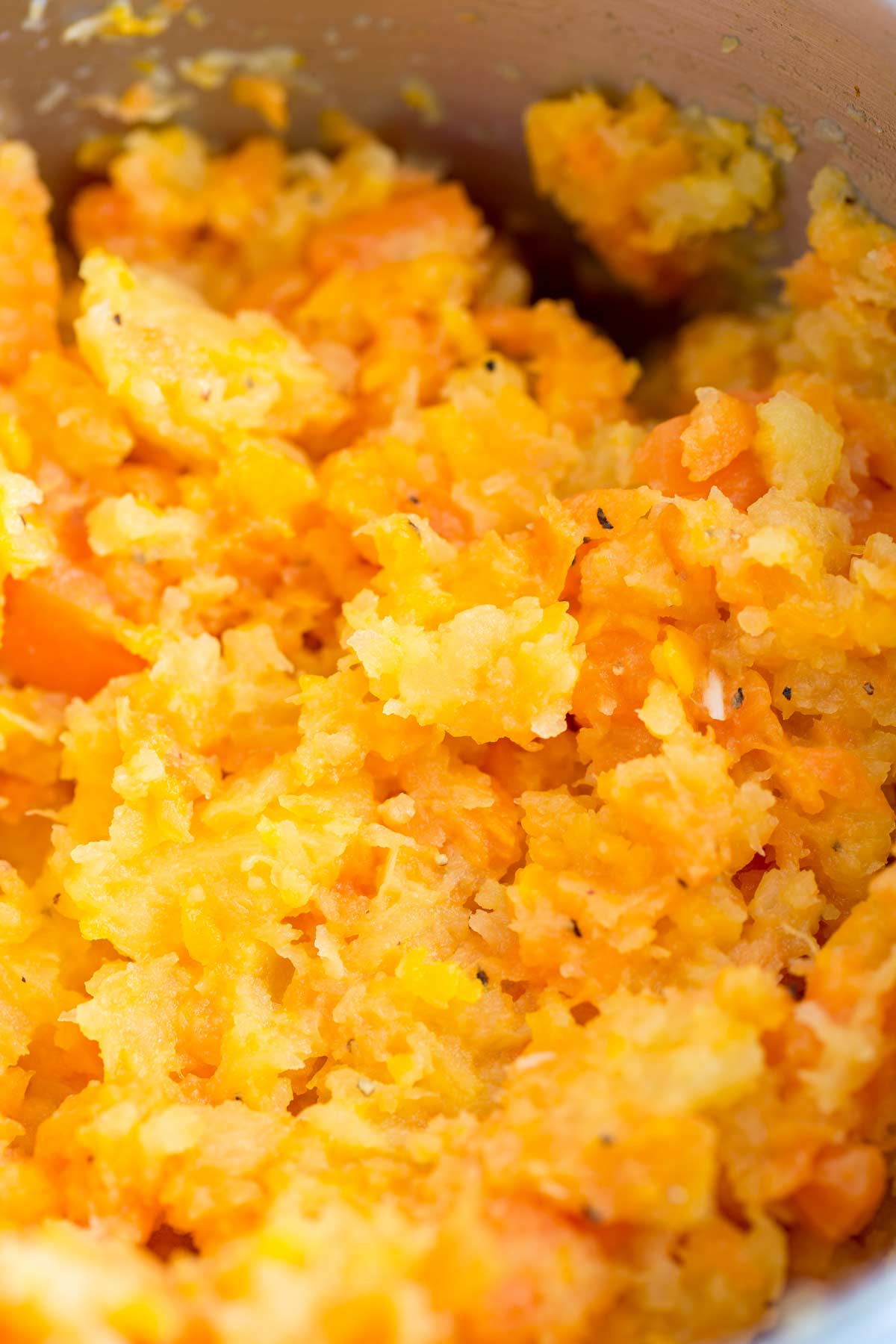 close up of mashed rutabaga and carrot showing the rough texture