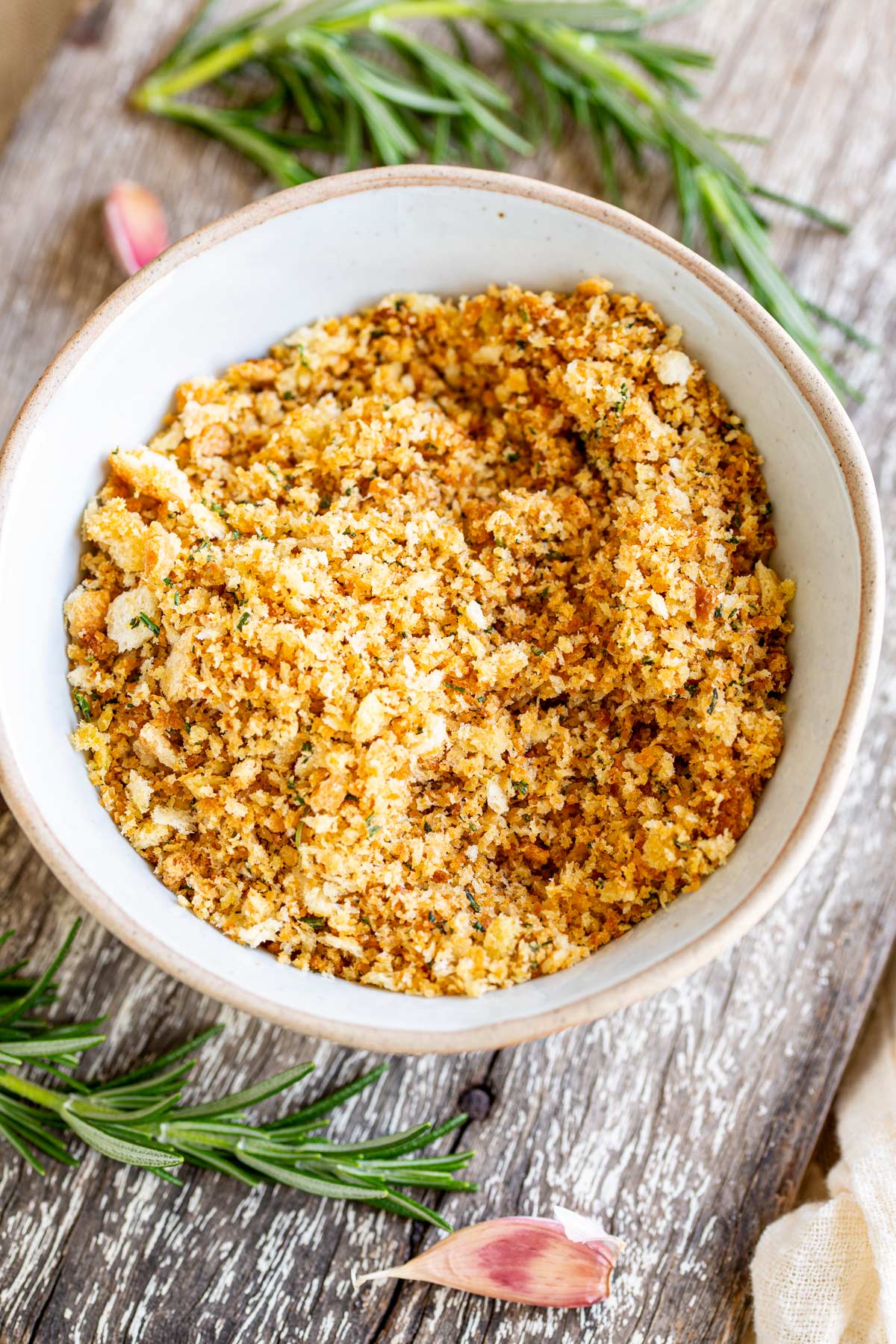 overhead view of a handmade bowl filled with crispy golden breadcrumbs
