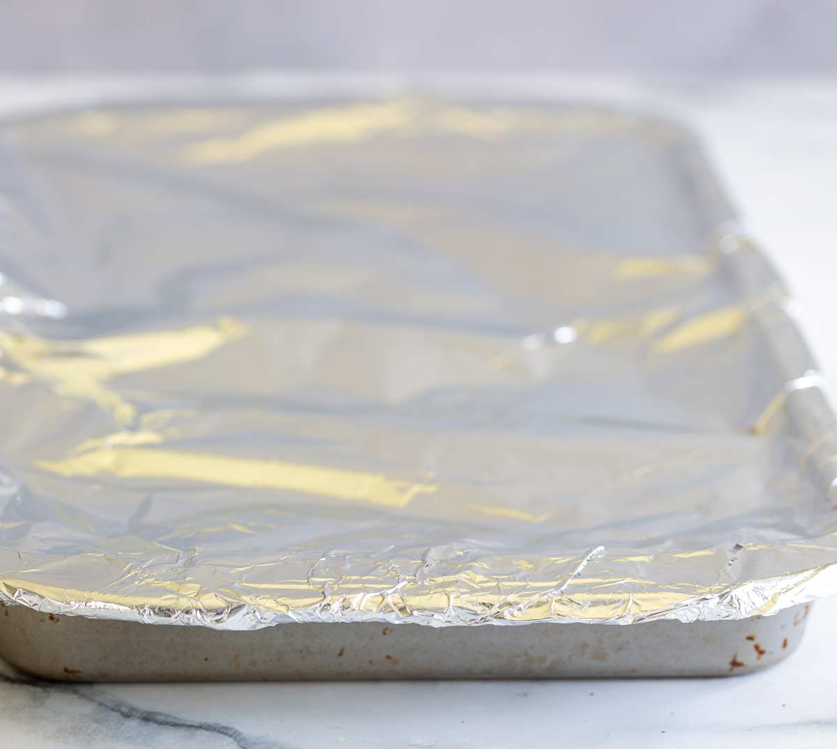 a roasting tray tightly covered with aluminium foil