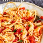 pin image: Spicy Shrimp Pasta in a rustic bowl with text overlaid