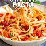 pin image: Spicy Shrimp Pasta in a rustic bowl with text overlaid