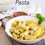 Pin Image: Creamy Chicken Pesto Pasta in a rustic bowl with text overlaid