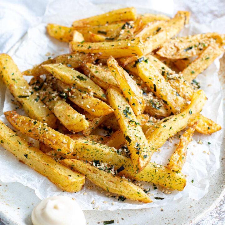 a pile of fries with sesame and seaweed on them