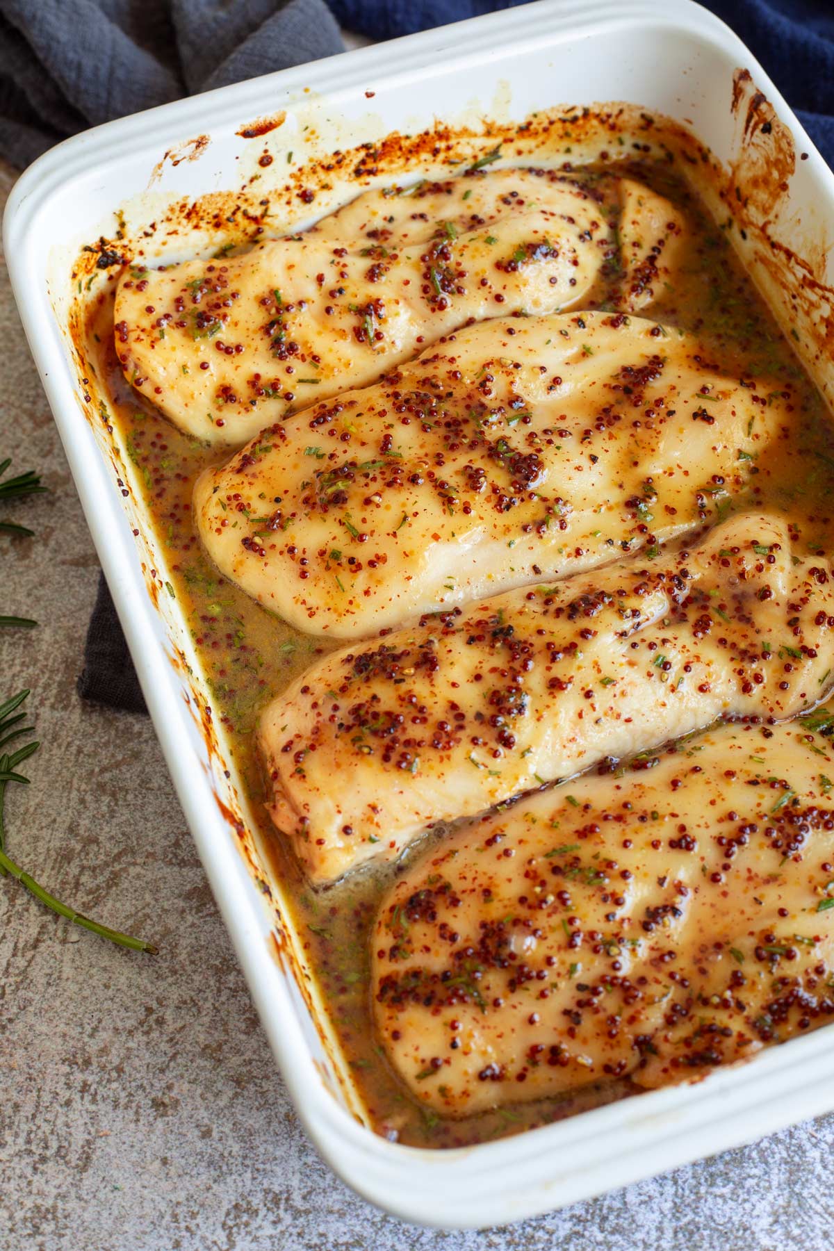 a tray of oven baked Honey Mustard Chicken Breasts a stone table