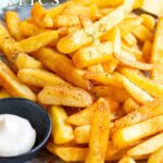 Pin Image: Cajun Fries on a plate with mayonnaise. Text overlaid