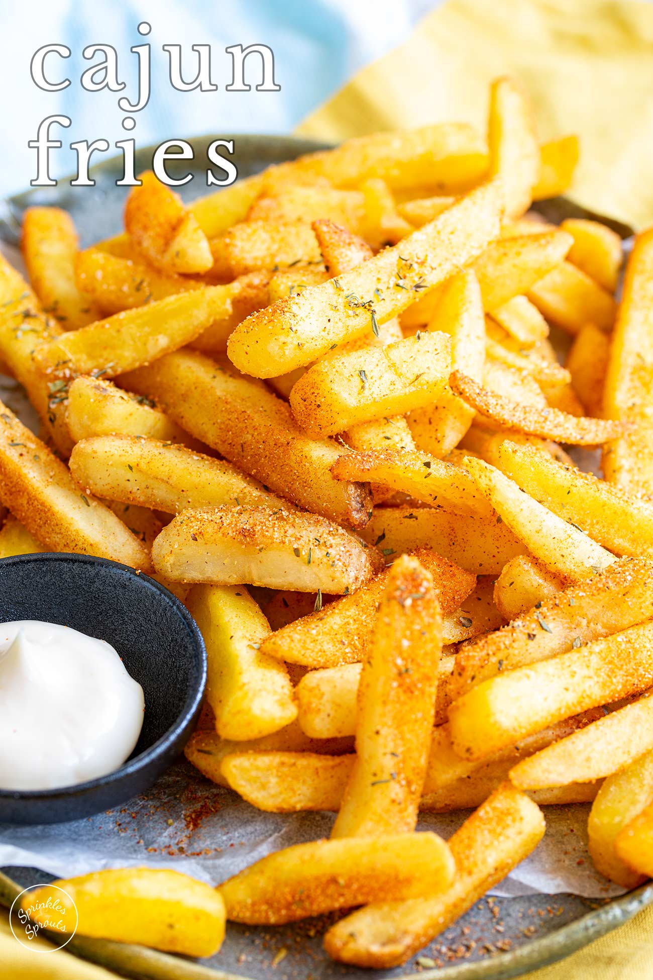 Pin Image: Cajun Fries on a plate with mayonnaise. Text overlaid