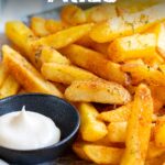 Pin Image: Cajun Fries on a plate with mayonnaise. Text overlaid