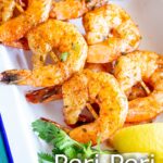 pin image: peri peri shrimp in a white dish with text overlaid