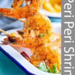 pin image: peri peri shrimp in a white dish with text overlaid