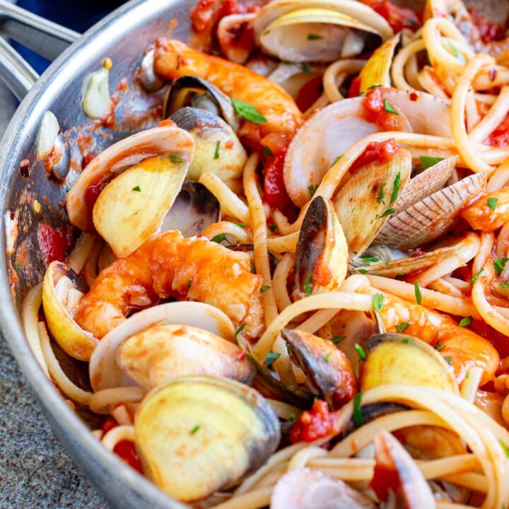close up on the seafood in a pan of pasta