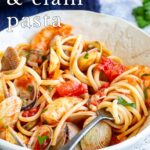 pin image: shrimp and clam pasta in a bowl with text overlaid
