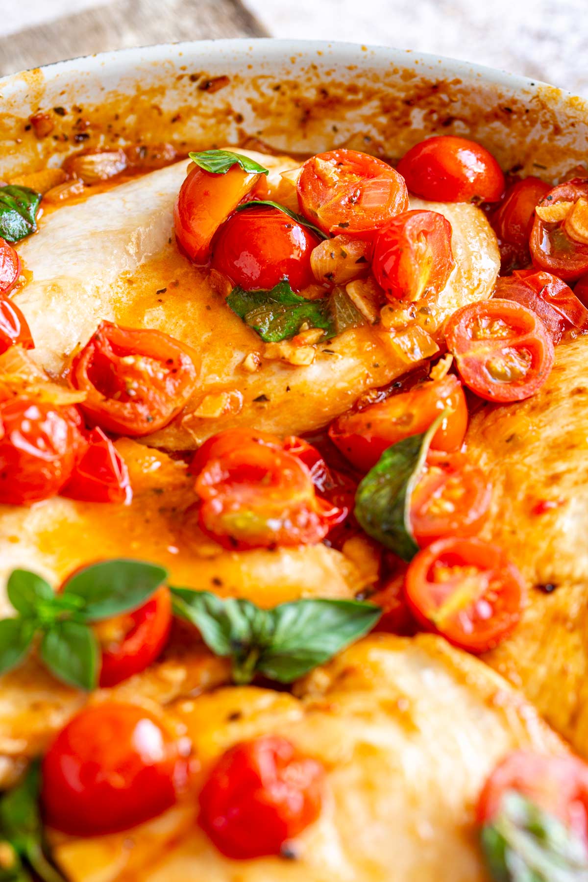 close up on a tomato sauce spooned over a cooked chicken cutlet