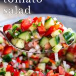 pin image: Moroccan tomato salad on a spoon with text overlaid