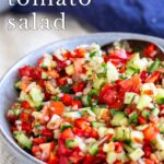 pin image: Moroccan tomato salad on a spoon with text overlaid