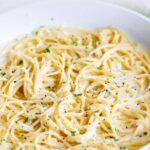 pin image: creamy pasta in a pan with text at the top and bottom