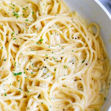close upon spaghetti strands in a creamy sauce