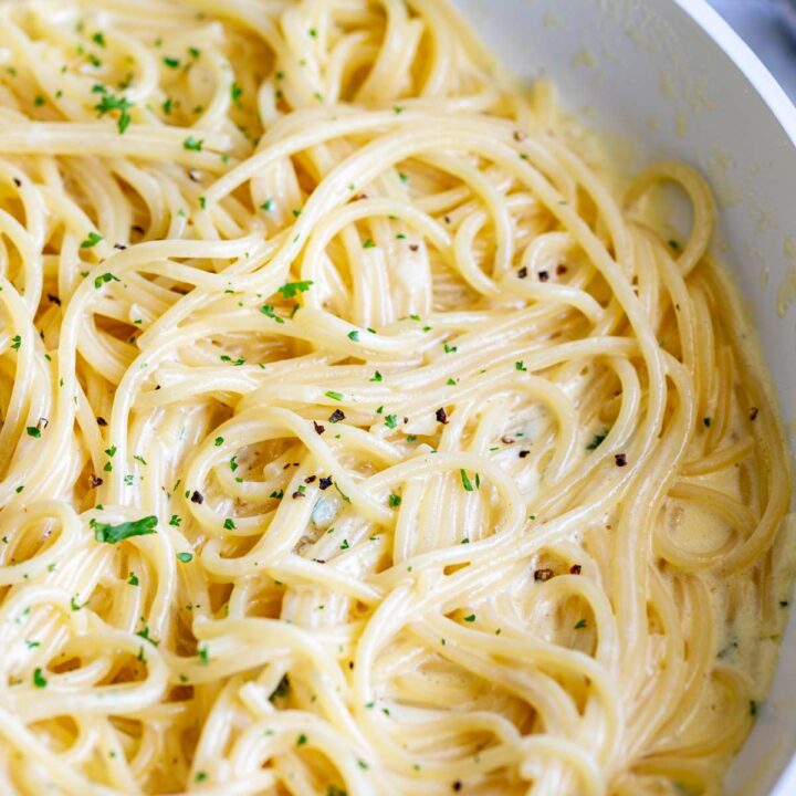 close upon spaghetti strands in a creamy sauce