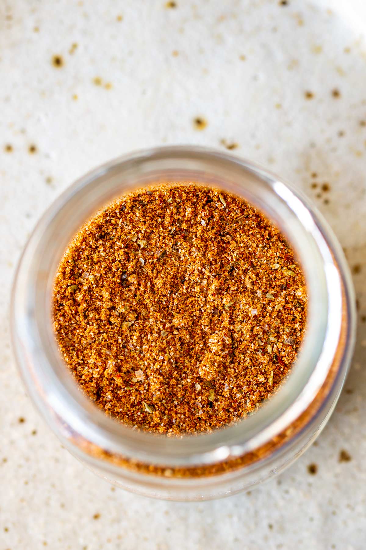 overhead of an open glass jar of seasoning