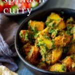 pin image: Saag aloo in a black bowl with text overlaid