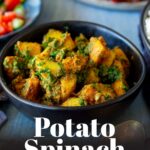 pin image: Saag aloo in a black bowl with text overlaid