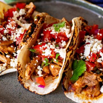 super close up of saucy shredded chicken in a tortilla