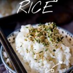 pin image: a small bowl of sticky rice sprinkled with furikake with text overlaid