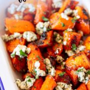 pin image: Roasted buffalo carrots topped with blue cheese with text overlaid