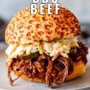 Pin Image: BBQ beef sandwich with pickles and slaw. With text overlaid