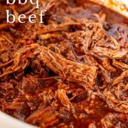 Pin Image: Shredded BBQ beef in a slow cooker. With text overlaid