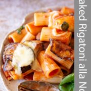 Pin Image: Plate of baked rigatoni alla Norma with side salad with text overlaid