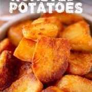 Pin Image: Close up of a bowl of roasted potatoes in a rustic dish with text overlaid
