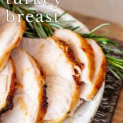 Pin Image: Sliced turkey breast on a plate with fresh rosemary with text overlaid