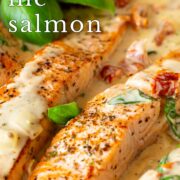 Pin Image: Salmon fillets in a creamy sun-dried tomato sauce with basil, with text overlaid
