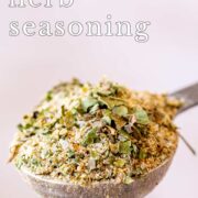 Pin Image: A spoon filled with garlic and herb seasoning with text overlaid