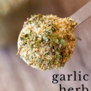 Pin Image: A spoon filled with garlic and herb seasoning with text overlaid
