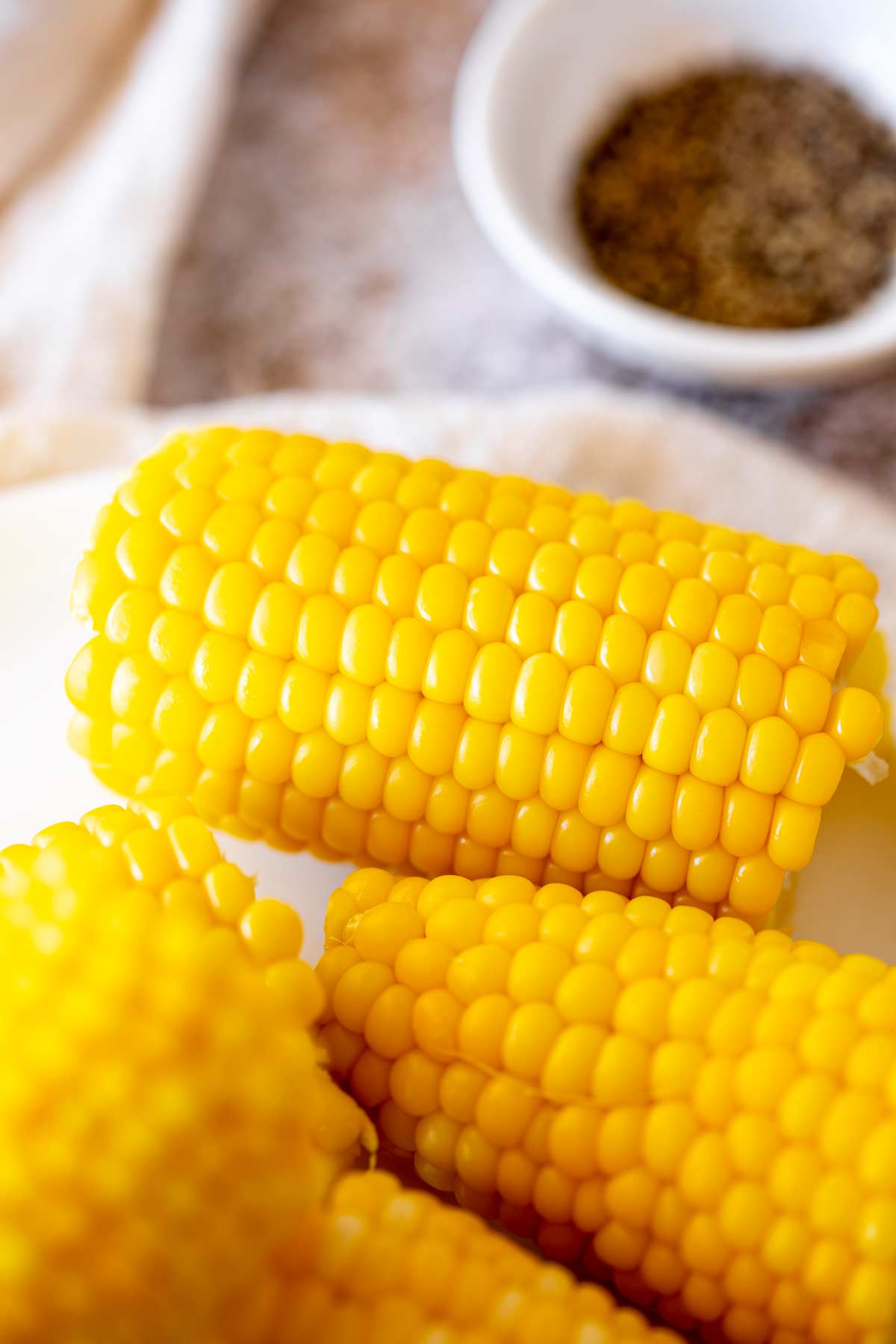 close up on half a cooked corn on the cob without the husk or silks
