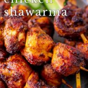 pin image: air fryer chicken shawarma skewers on a rustic blue grey plate with text overlaid