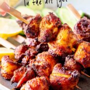 pin image: air fryer chicken shawarma skewers on a rustic blue grey plate with text overlaid