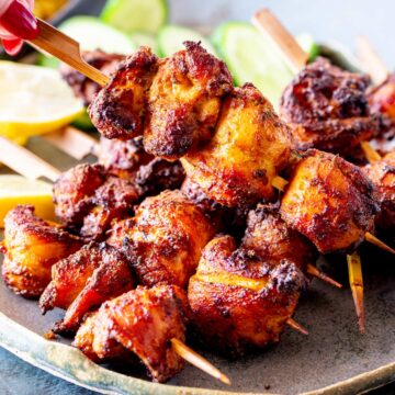 A detailed close-up of air fryer chicken shawarma skewers, highlighting the charred, spiced surface and juicy texture.