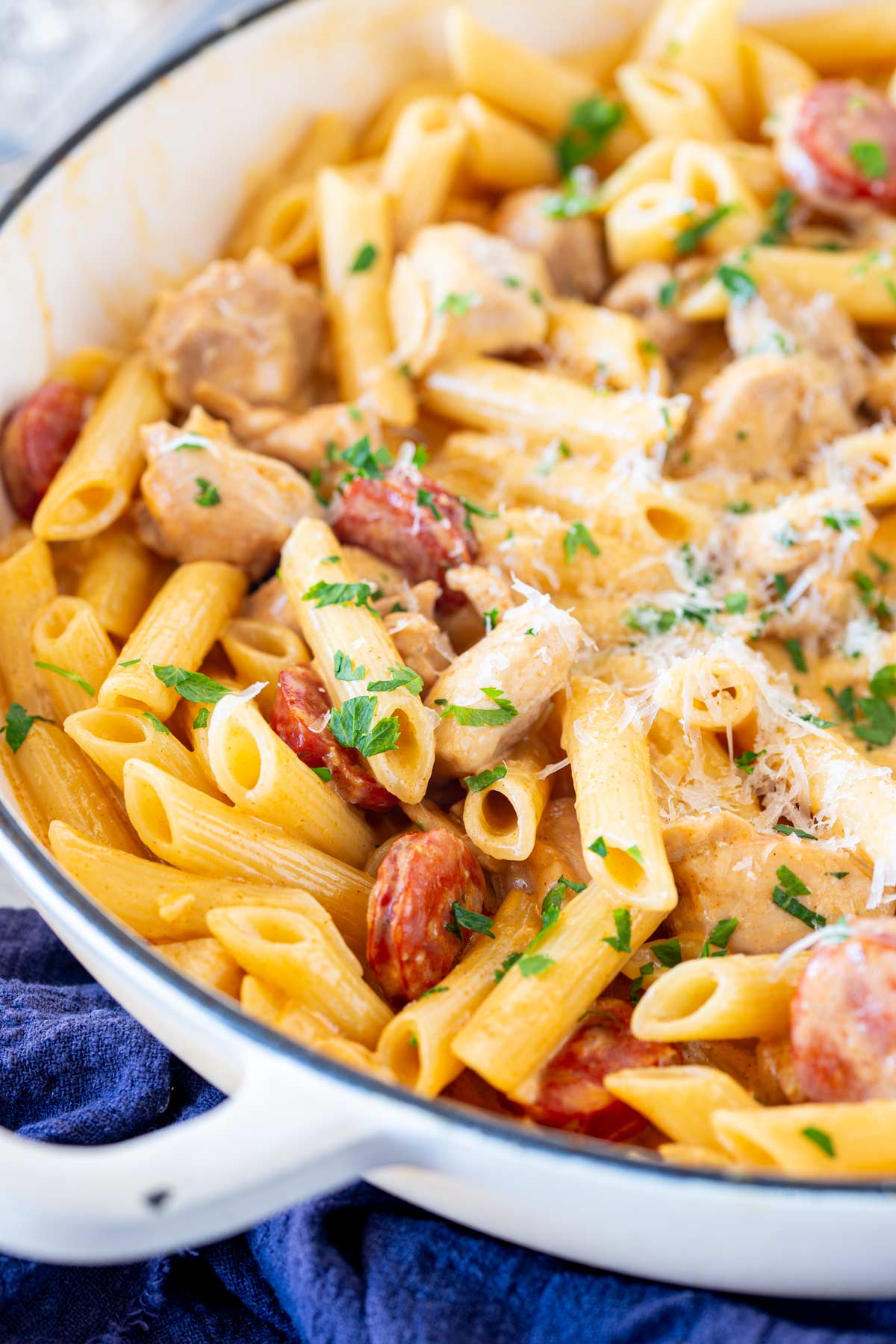 Overhead view of creamy pasta with chicken and chorizo in a cream pan.