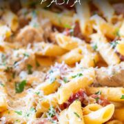 Pin Image: Creamy chicken and chorizo pasta in a pan with text overlaid.