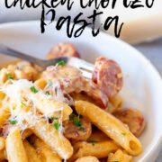 Pin Image: Creamy chicken and chorizo pasta in a shallow bowl with text overlaid.