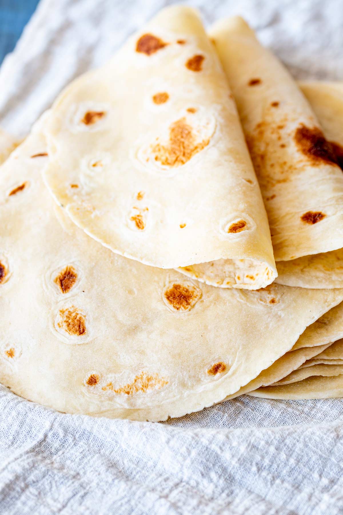 two folded flatbreads on a stack of flatbreads