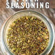 Pin Image: Pizza seasoning in a glass jar with text overlaid