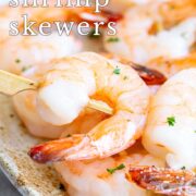 Pin Image: Shrimp skewers on serving plate with text overlaid