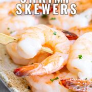 Pin Image: Shrimp skewers on serving plate with text overlaid