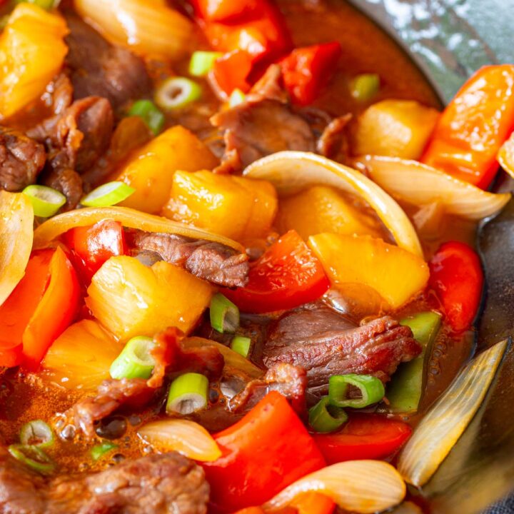 a close up on sweet and sour beef with peppers and onions