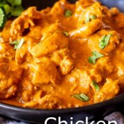 Pin Image: Close-up of golden Chicken Korma in black bowl with text overlaid