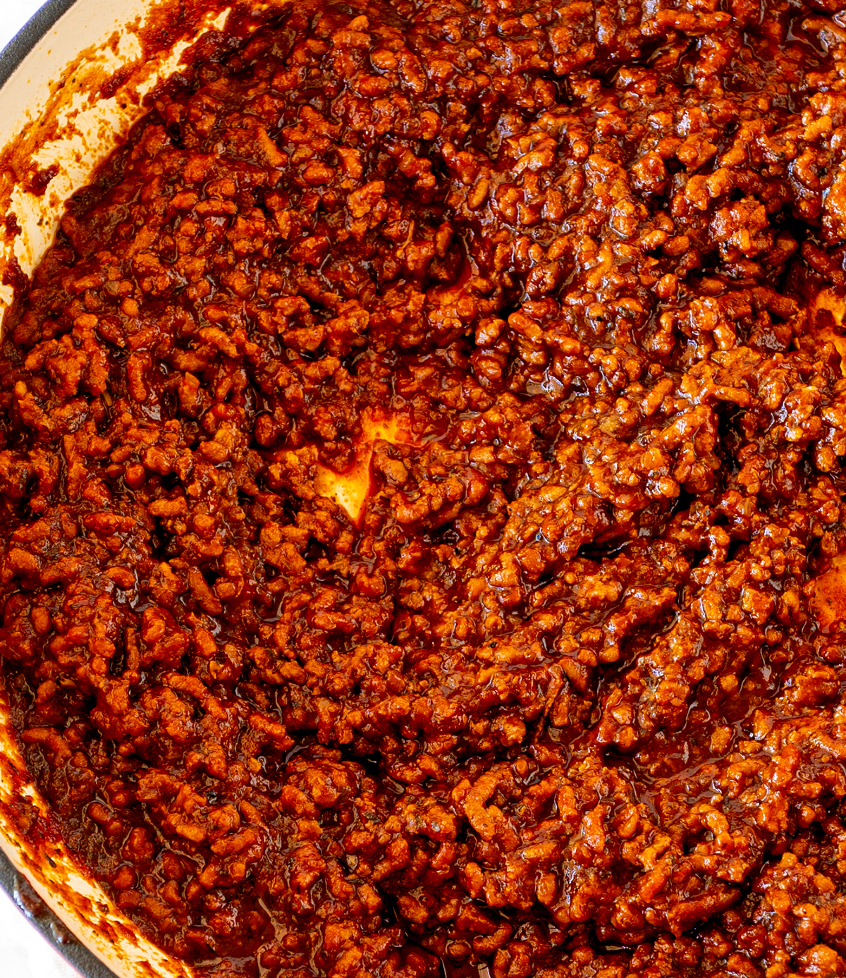 A close-up of the cooked chili sauce, highlighting its thick, hearty texture