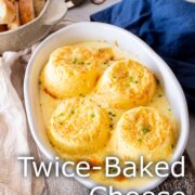 Pin Image: Four cheese soufflés in rustic white baking dish with text overlaid